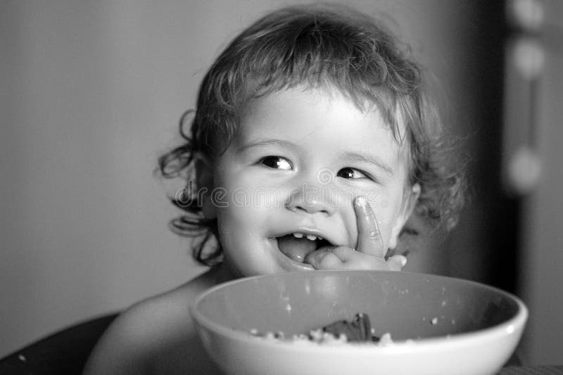 Healthy Nutrition for Kids. Funny Baby Eating Food Himself with a Spoon ...