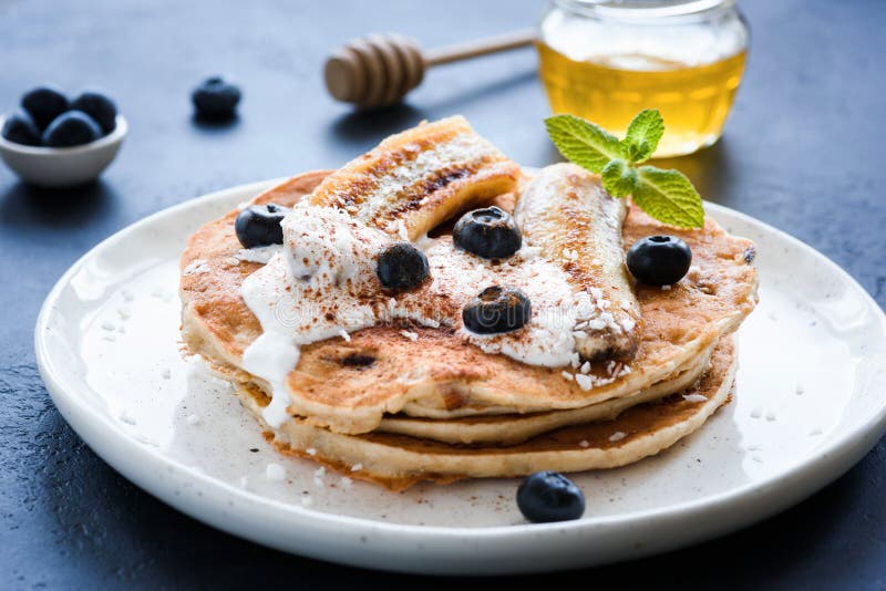 Healthy oat pancakes with banana, blueberries and yogurt