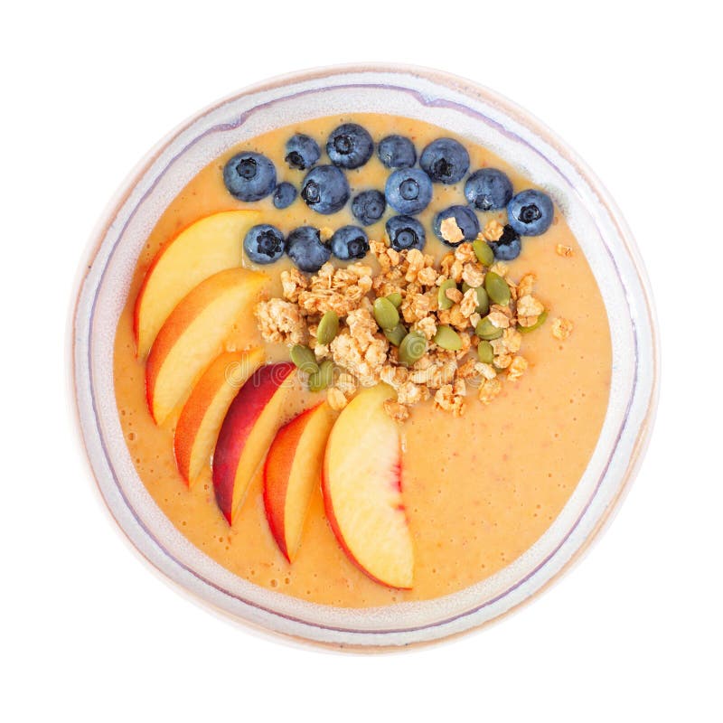 Healthy peach smoothie bowl with blueberries and granola isolated on white