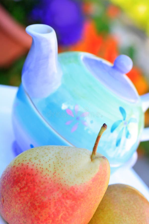 Healthy pears and teapot close up