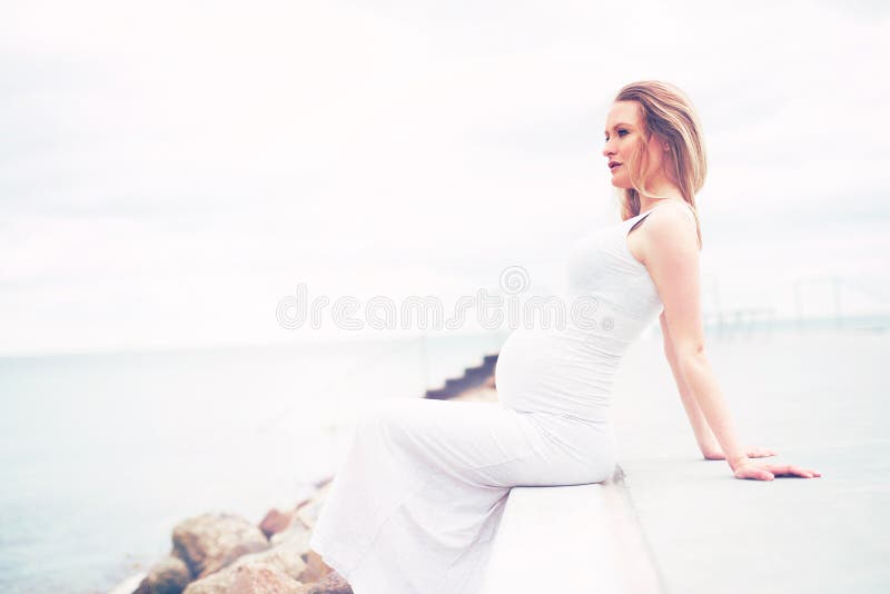 Healthy pregnant woman relaxing at the seaside stock photos Healthy pregnant woman relaxing at the seaside stock photos