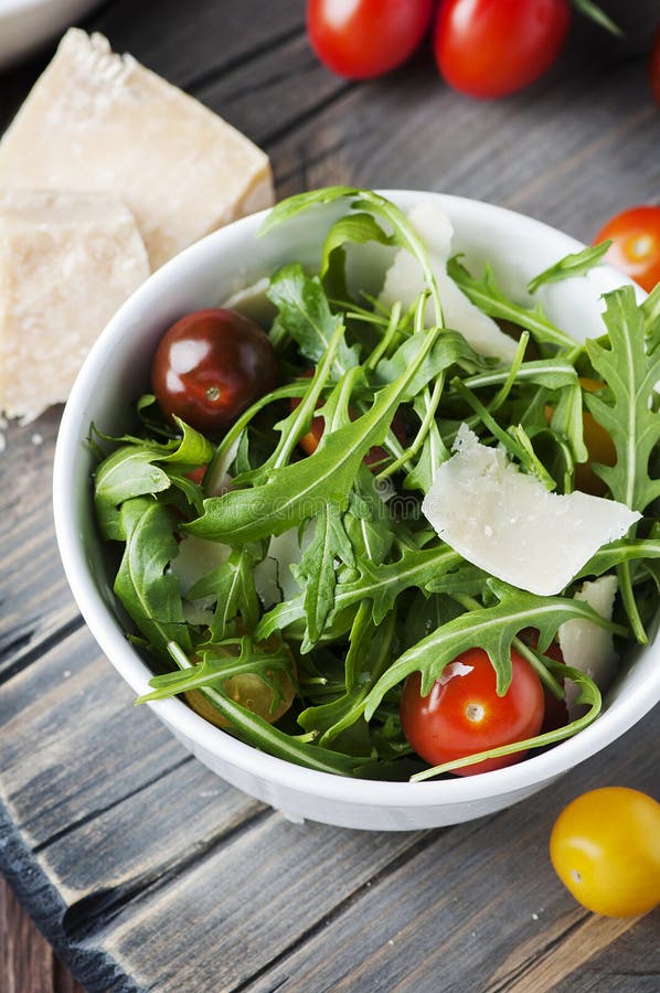 Healthy Salad with Rocket, Tomato and Parmesan Cheese Stock Photo