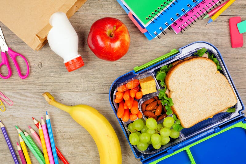 Healthy school lunch box and school supplies. Bottom border, top