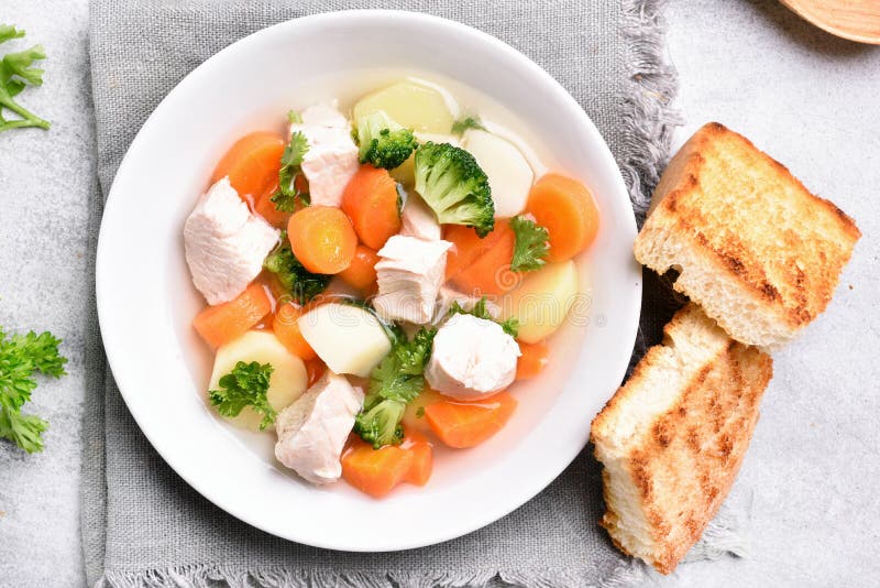 Healthy soup from carrot, potato, broccoli and chicken breast