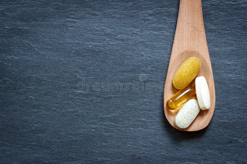 Healthy supplements on wooden spoon royalty free stock photos Healthy supplements on wooden spoon royalty free stock photos