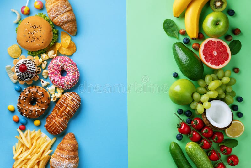 Healthy and unhealthy food background from fruits and vegetables vs fast food, sweets and pastry.Diet and detox against calorie stock photography Healthy and unhealthy food background from fruits and vegetables vs fast food, sweets and pastry.Diet and detox against calorie stock photography