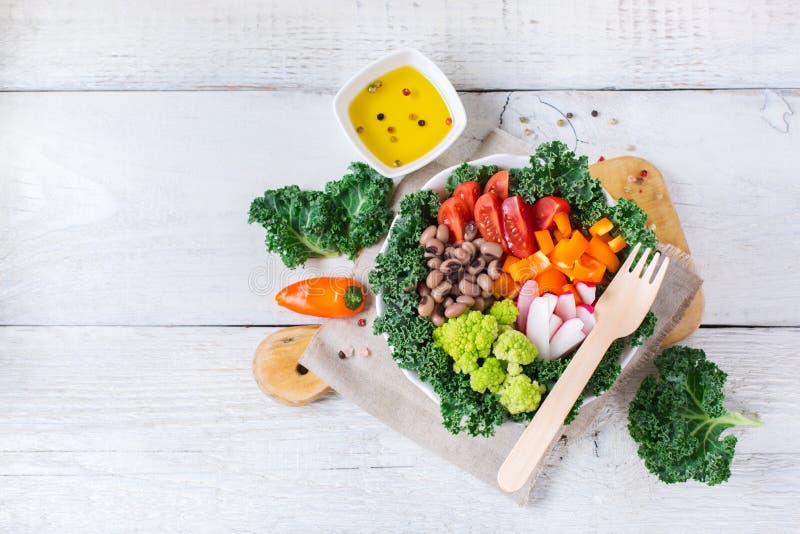 Healthy vegan buddha bowl with kale leaves and raw vegetables royalty free stock image Healthy vegan buddha bowl with kale leaves and raw vegetables royalty free stock image