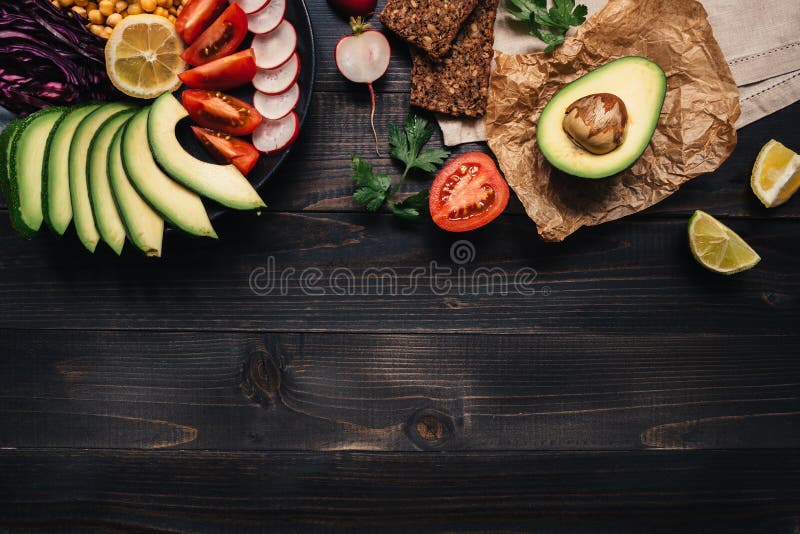 Healthy vegan food concept. Healthy food with vegetables and whole wheat bread on the wooden table top view. Copy space stock photography Healthy vegan food concept. Healthy food with vegetables and whole wheat bread on the wooden table top view. Copy space stock photography
