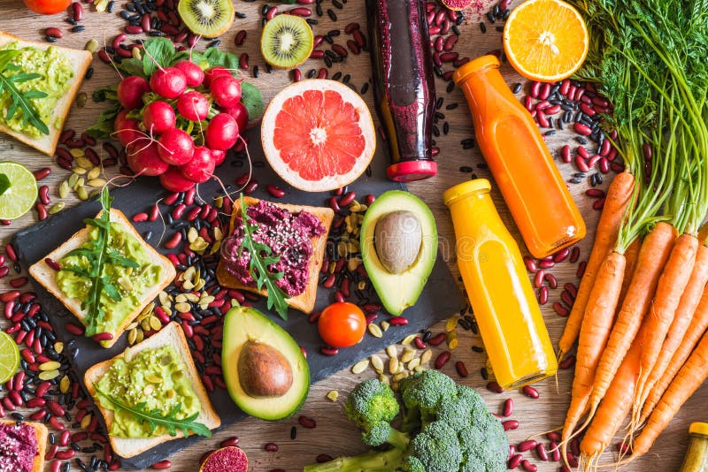 Healthy vegan food. Sandwiches and fresh vegetables on wooden background. Detox diet. Different colorful fresh juices. top view. Healthy vegan food. Fresh stock images