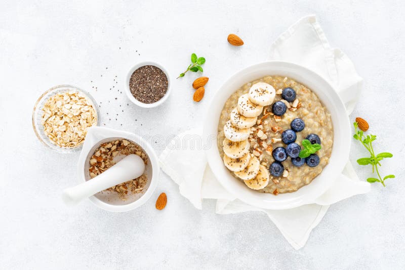 Healthy vegetarian food, oatmeal with fresh blueberry, banana, almond nuts and chia seeds for breakfast