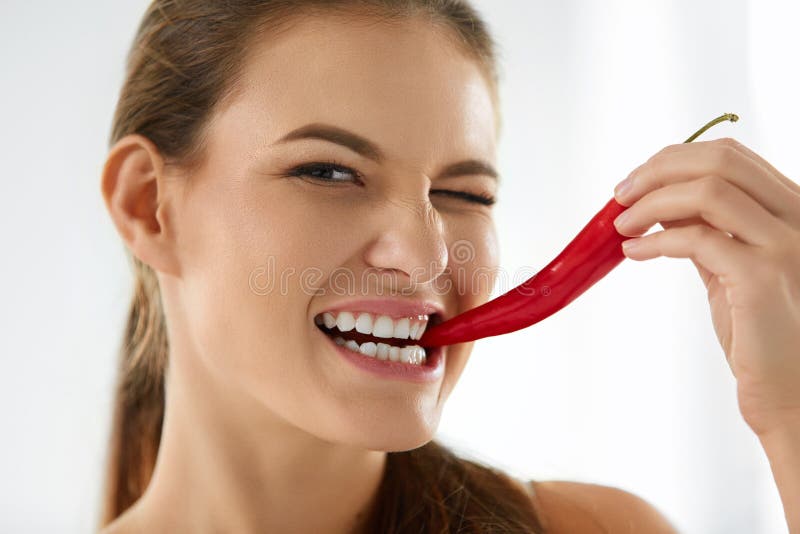 Healthy Woman Eating Spicy Red Chili Pepper. Diet, Food Concept.