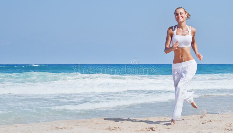 Healthy woman running on the beach