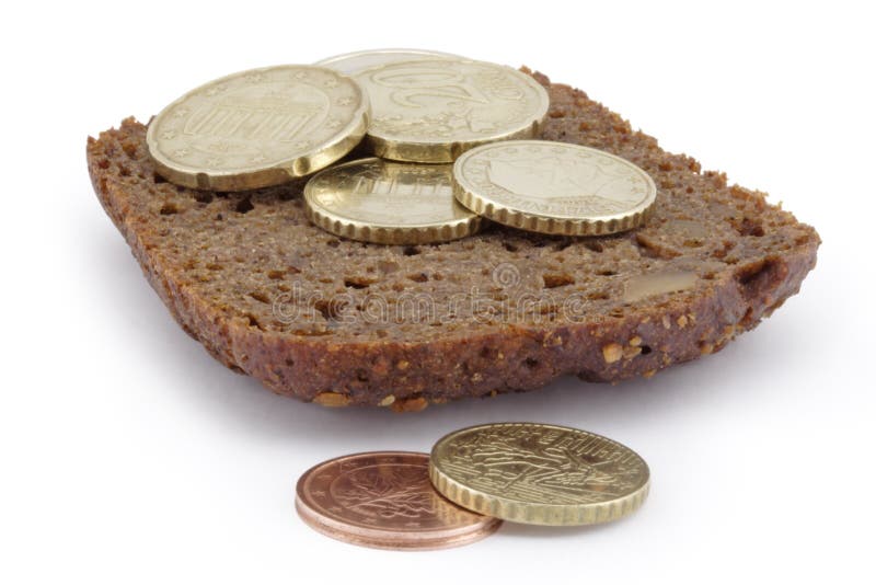 Heap of coins on a slice of bread. stock photos
