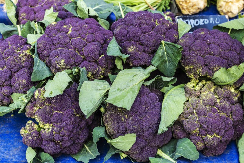 Heap of purple broccoli in a farmer market on a street as background in Athens, Greece. Heap of purple broccoli in a farmer market on a street as background in Athens, Greece