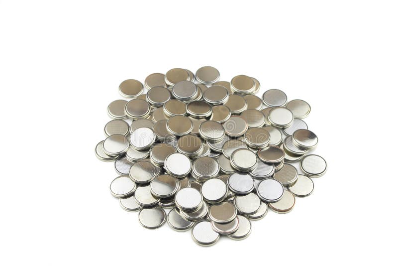 Heap of lithium button cell batteries. Isolated on white background. Closeup stock images Heap of lithium button cell batteries. Isolated on white background. Closeup stock images