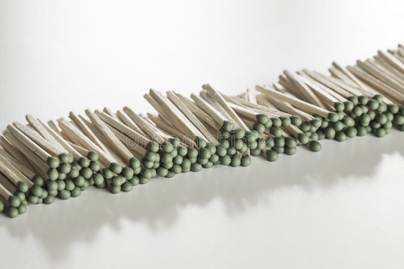 Heap of Matches with Green Heads on a White Background Stock Photo
