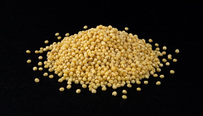 Heap of millet isolated on black background royalty free stock photo