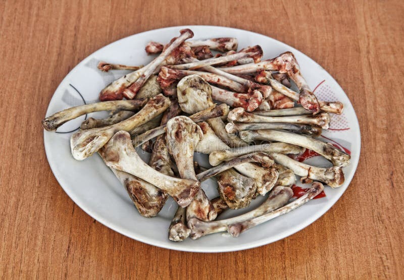 Heap of Picked Chicken Bones on a Plate. Stock Photo - Image of crisis