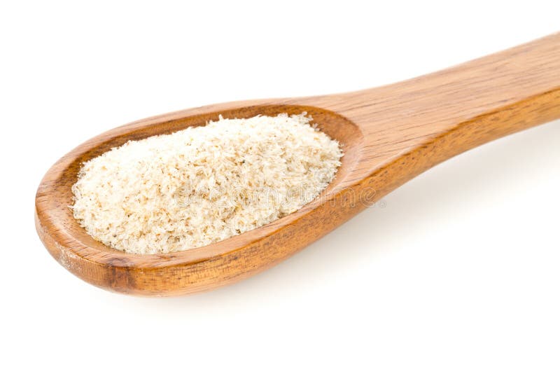 Heap of psyllium husk also called isabgol in wooden spoon over white backgr...