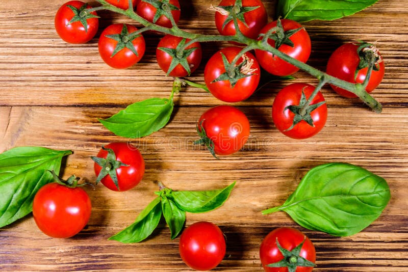 Heap of Small Cherry Tomatoes on Wooden Table. Top View Stock Photo