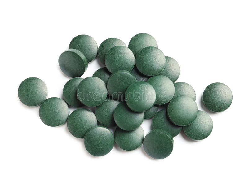 Heap of spirulina tablets on white background