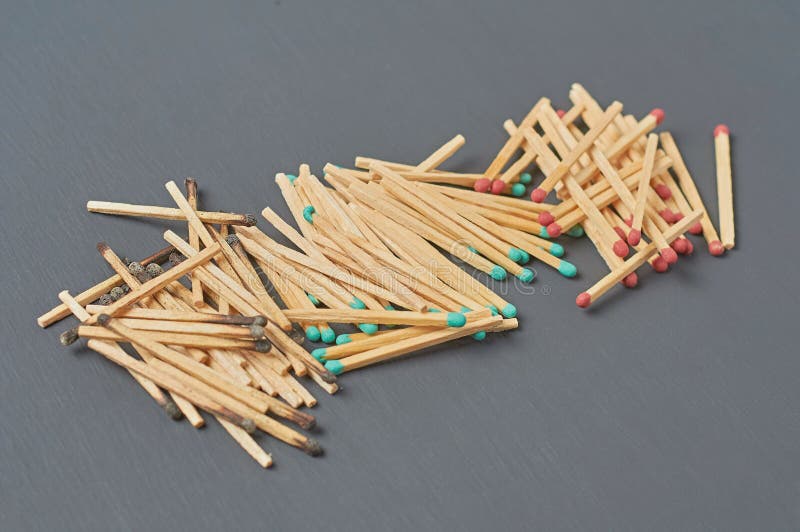 Heaps of many used and new matchsticks on dark concrete table on kitchen
