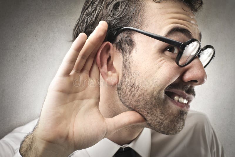 Businessman trying to hear carefully