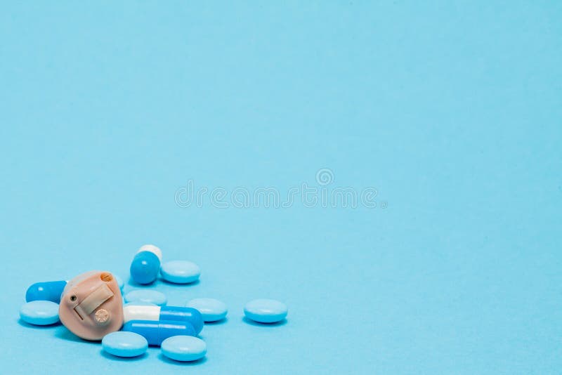 Hearing Aid and Blue Pills on Blue Background. Medical, Pharmacy and  Healthcare Concept. Copy Space Stock Photo - Image of empty, difficulty:  145469804