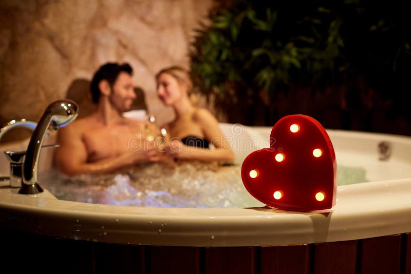 Heart on a background of a romantic couple with champagne in the royalty free stock image Heart on a background of a romantic couple with champagne in the royalty free stock image