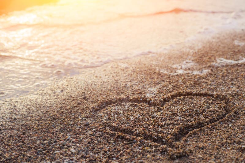 Heart Drawing in the Sand Beach. Romantic Composition Stock Image