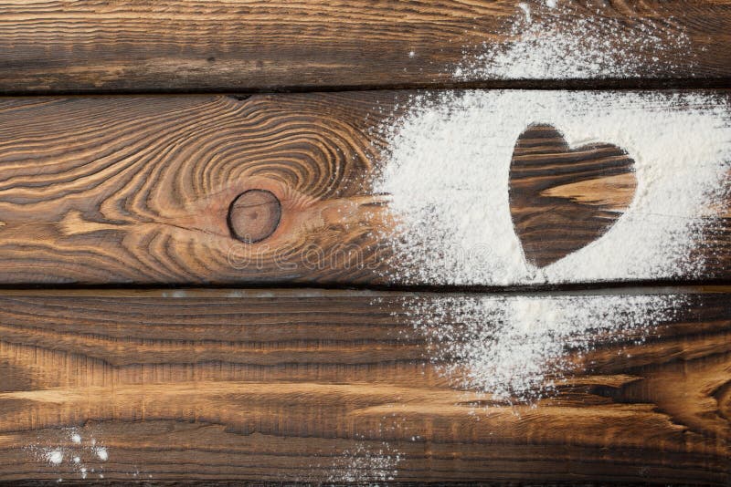 Heart free space. Heart made of flour on a wooden background stock images Heart free space. Heart made of flour on a wooden background stock images