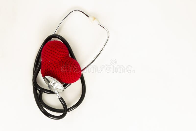 Heart health and prevention concept. Stethoscope and red heart of crochet on white isolated background with space for text royalty free stock photography Heart health and prevention concept. Stethoscope and red heart of crochet on white isolated background with space for text royalty free stock photography