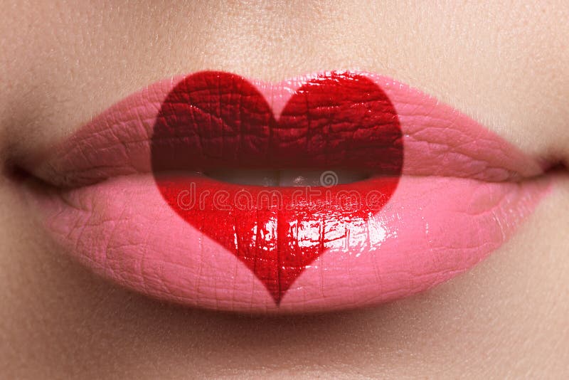 Heart kiss on the Lips. Beauty full lips with heart shape paint. Valentines Day. Beautiful make-up. Lipstick and lipgloss stock image Heart kiss on the Lips. Beauty full lips with heart shape paint. Valentines Day. Beautiful make-up. Lipstick and lipgloss stock image