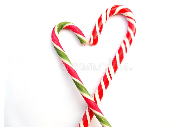 Heart made of candy canes on white background