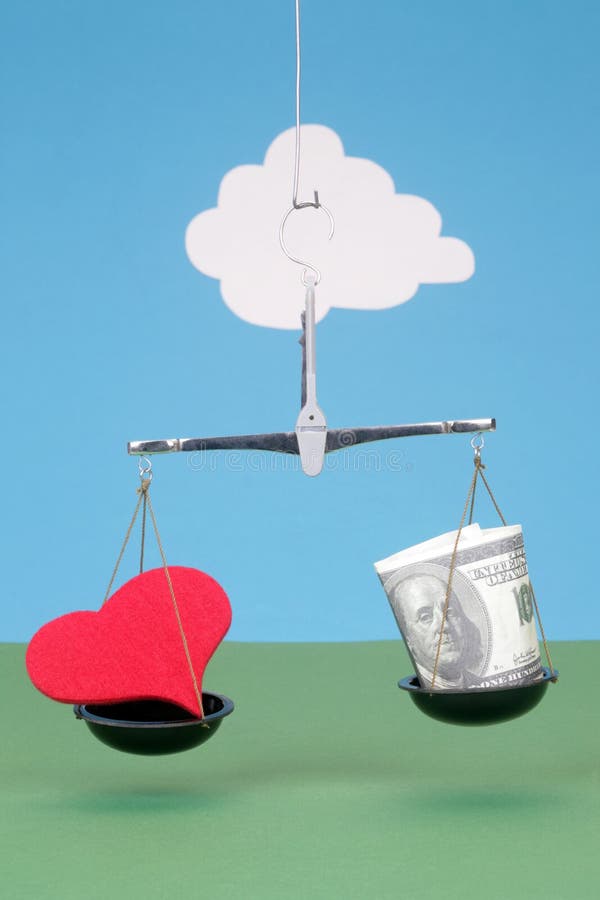 Heart and money on scales
