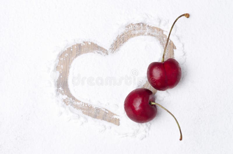 Heart painted on the backdrop of powdered sugar and two cherries