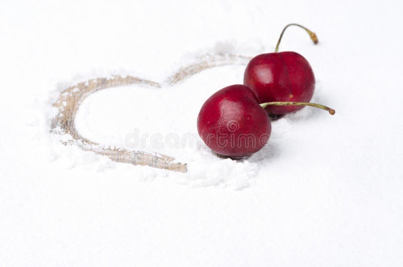 Heart painted on the backdrop of powdered sugar and two cherries