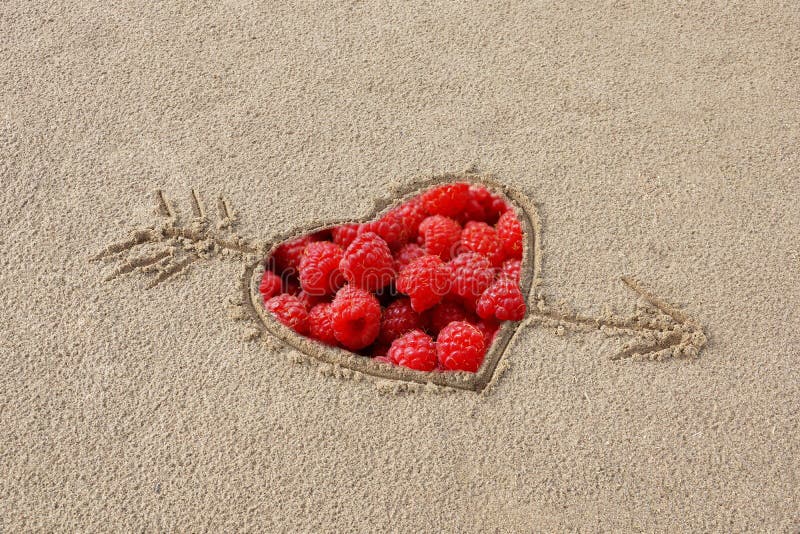 heart pierced by an arrow drawing on the sand beach inside the r stock photos heart pierced by an arrow drawing on the sand beach inside the r stock photos