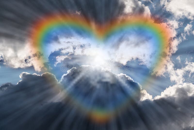 World of Hearts movement offering Hope during Pandemic with a Rainbow Heart in the Sky with Clouds and God Rays of Light Shining Through. World of Hearts movement offering Hope during Pandemic with a Rainbow Heart in the Sky with Clouds and God Rays of Light Shining Through.