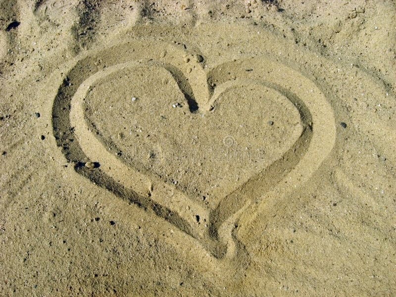 Heart on sandy surface