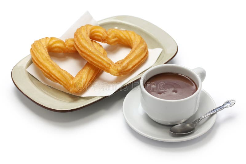 Heart shape churros and hot chocolate on white background stock image