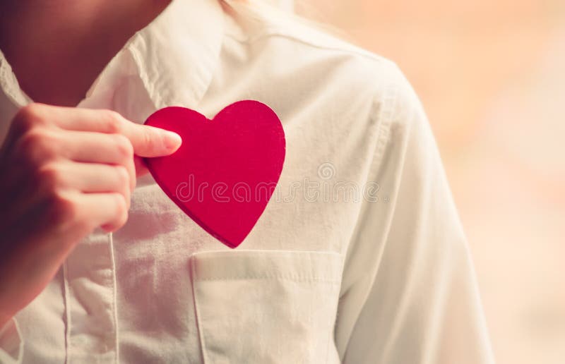 Heart shape love symbol in woman hands