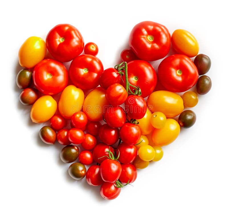 Heart shape by various tomatoes isolated on white background