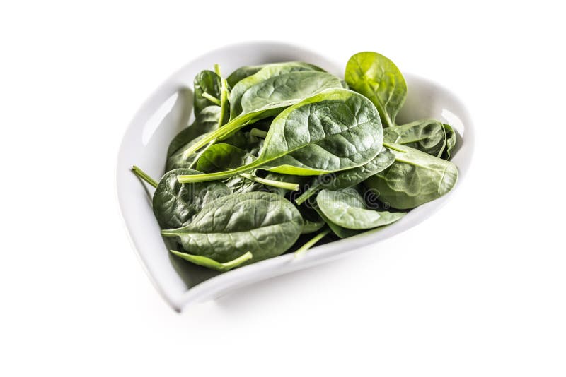 Heartshaped Bowl of Young Spinach Leaves on an Isolated White