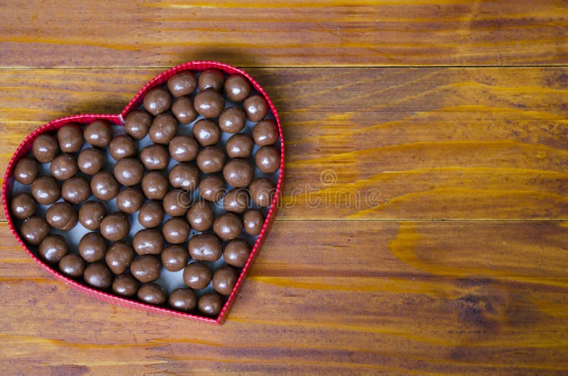 Heart shaped box filled with small chocolates balls