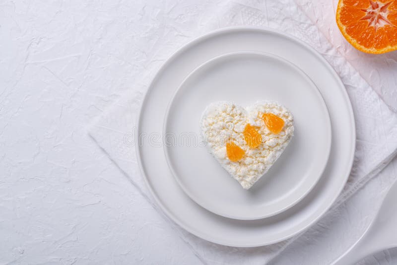 Heart Shaped Cottage Cheese and Orange in a Plate on a White Table