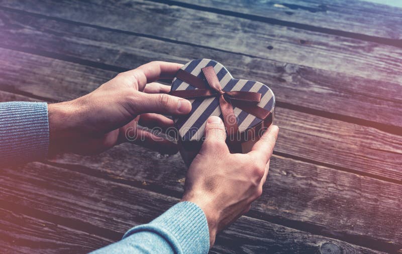Heart Shaped Gift Box in Man`s Hands. Stock Photo Image of celebrate