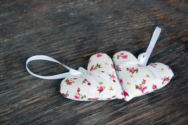 Heart shaped lavender bags on wooden table