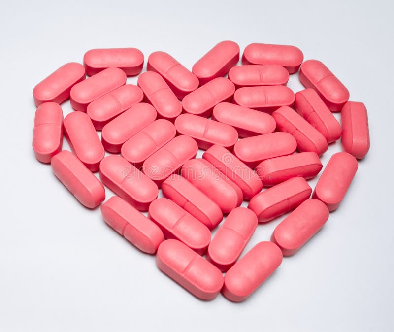 Pink pills arranged as the heart shaped. able to use in the the meaning of ...