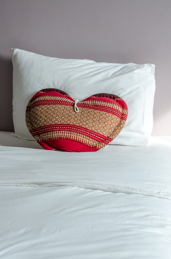 Heart Shaped Pillow on White Bed and White Pillow. Stock Photo Image of handmade, heart 56423526